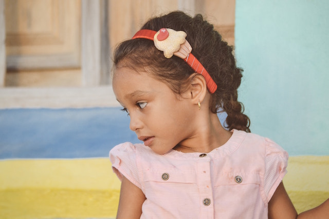 young girl sitting on bench